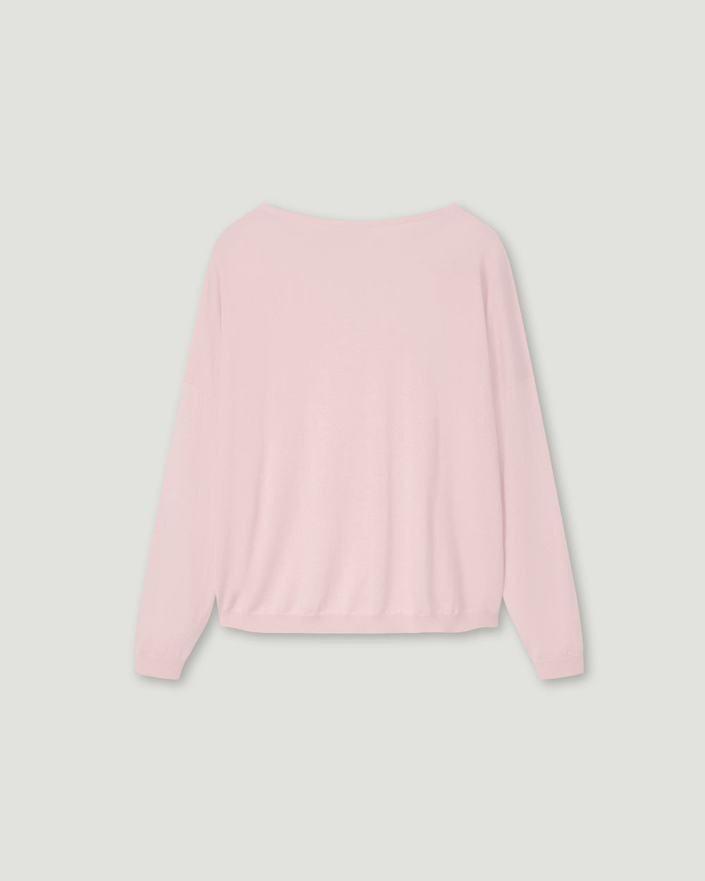 Pink sweater on a light gray background