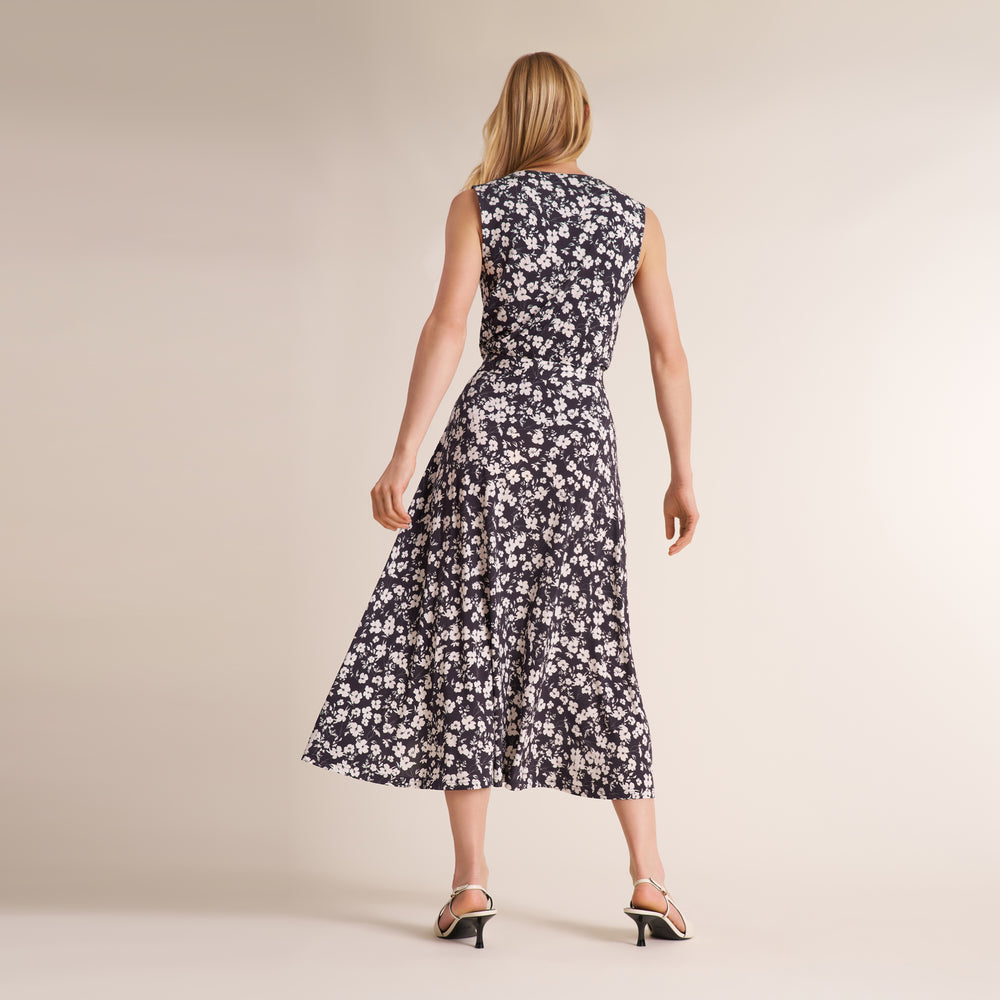 Woman wearing a matching shirt and long skirt in a black and white matching floral print