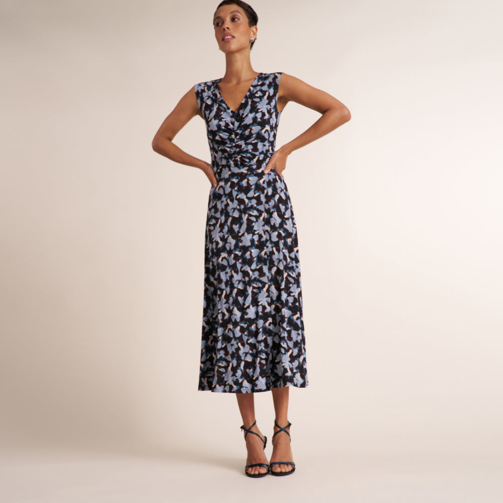Woman wearing a navy and light blue printed top with a matching long skirt