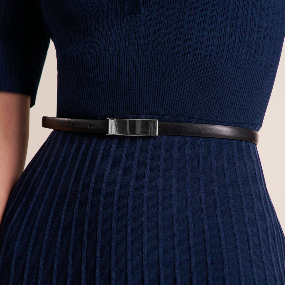 Woman wearing a three quarter sleeve dress with a midi pleated skirt