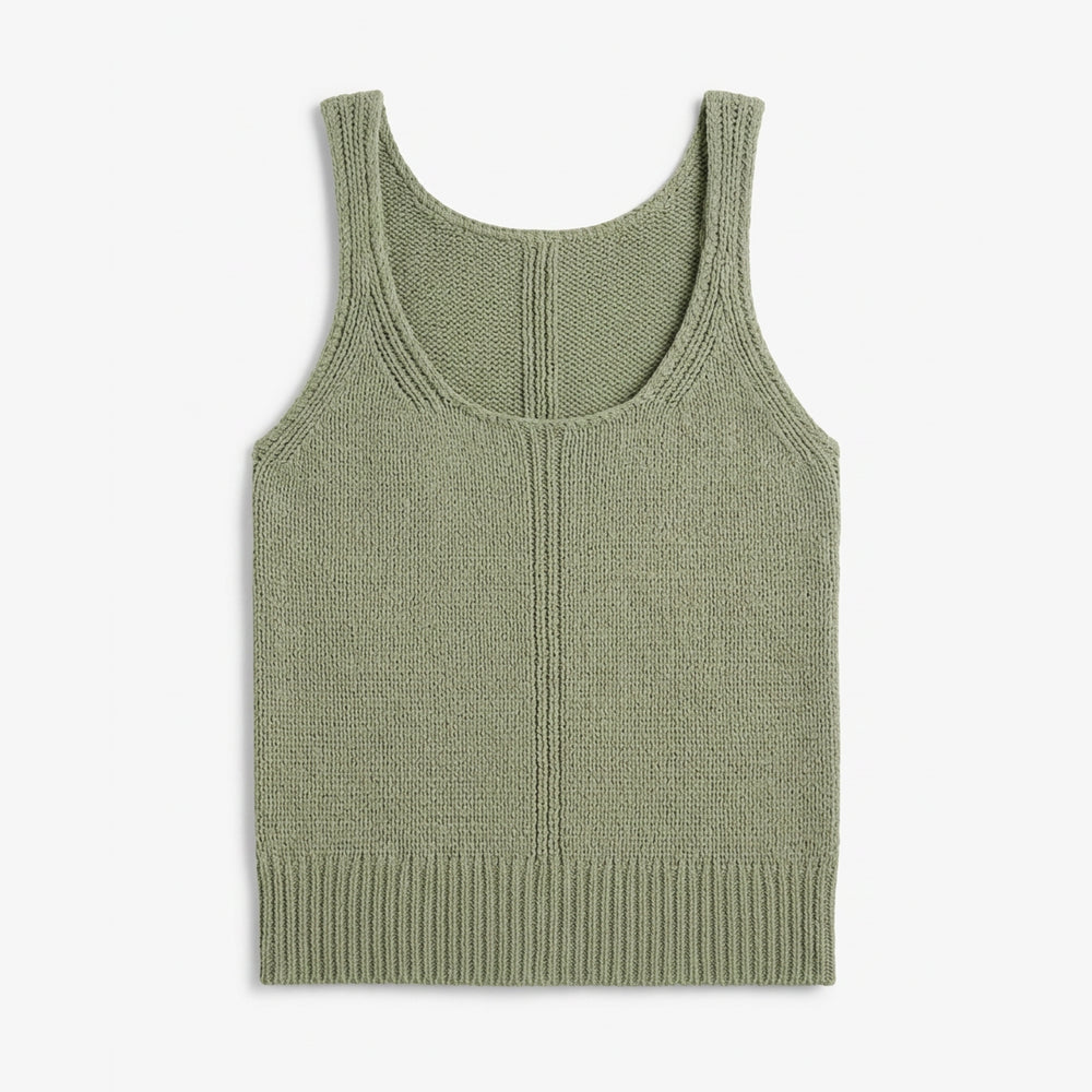 Green knitted tank top on a white background
