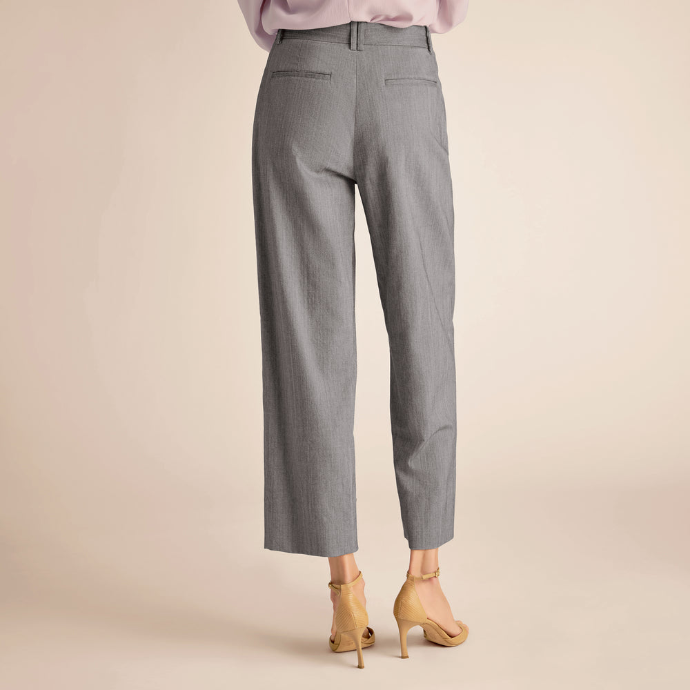 Gray pants worn by a person on a beige background
