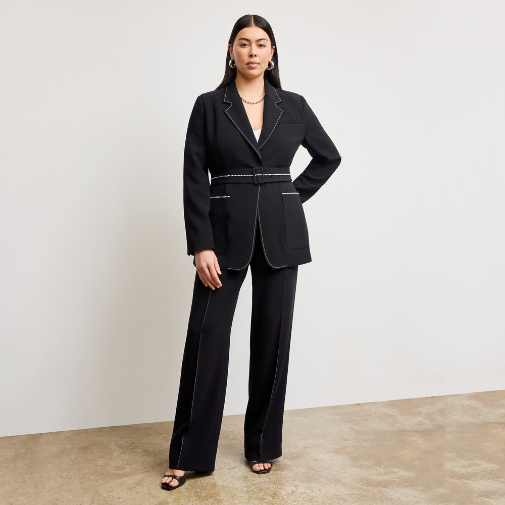 front image of a woman wearing the athena blazer in black with topstitch
