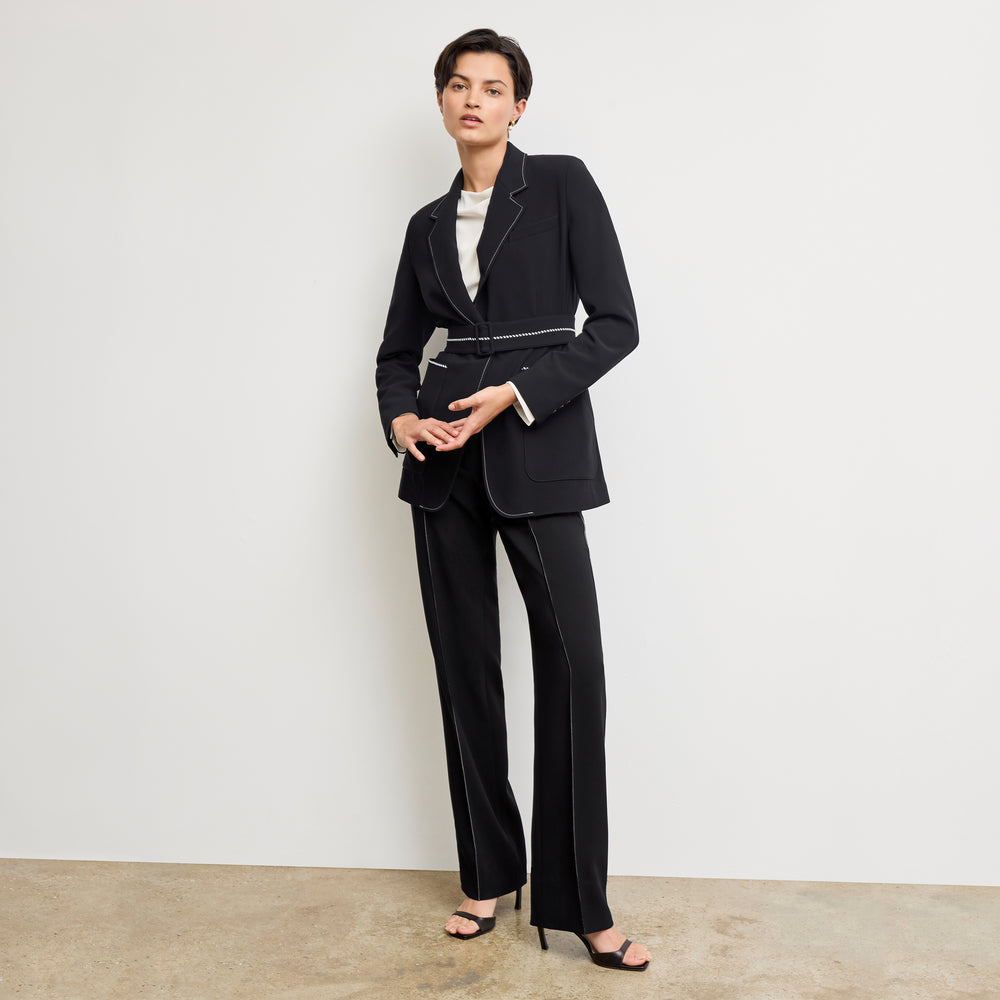front image of a woman wearing the athena blazer in black with topstitch