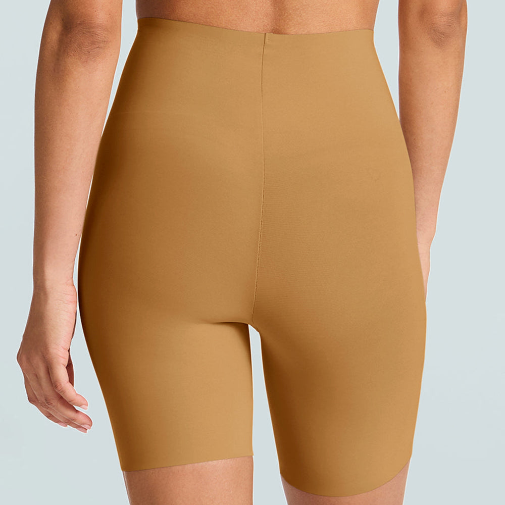 Person wearing mustard yellow high-waisted shorts on a light gray background