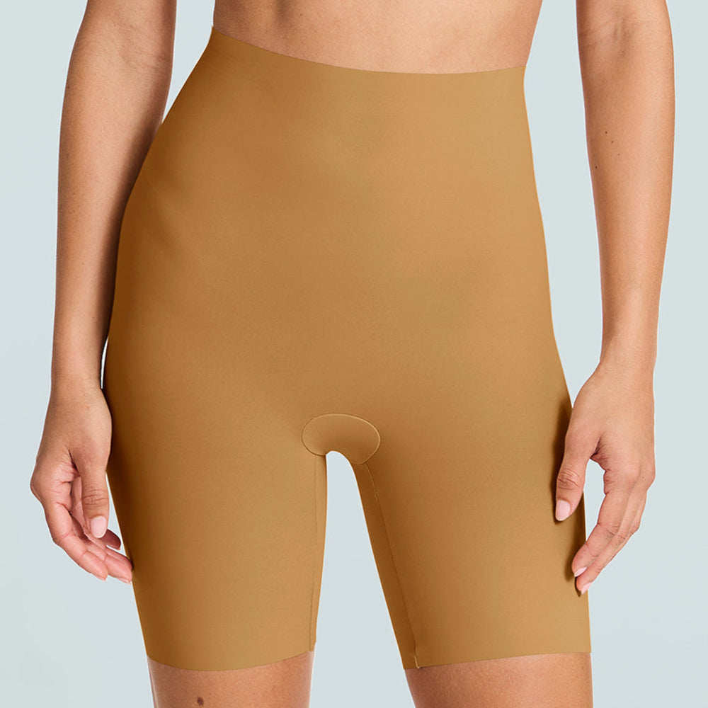 Person wearing tan high-waisted shapewear shorts on a light gray background