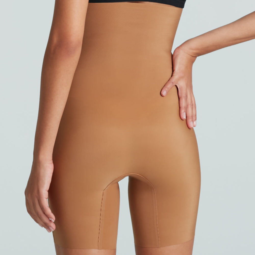 Tan shapewear being worn by a person on a plain background