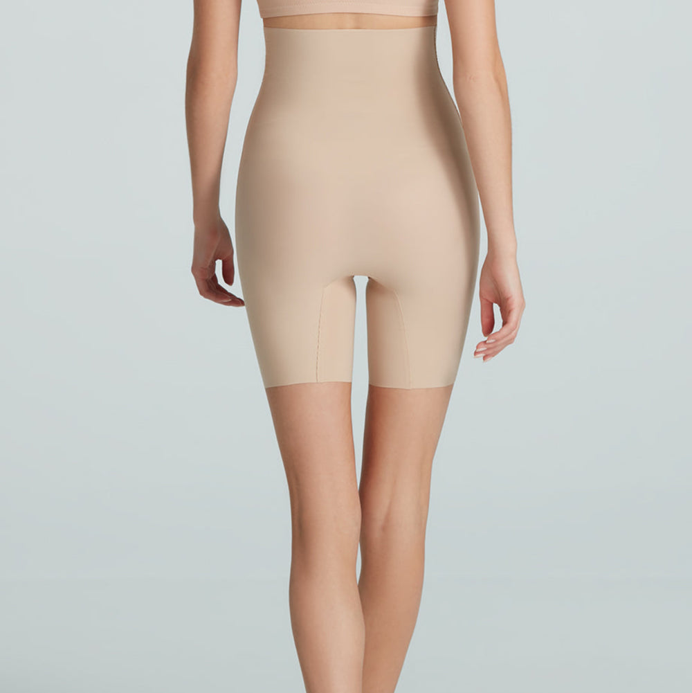 Beige shapewear worn by a model on a plain background