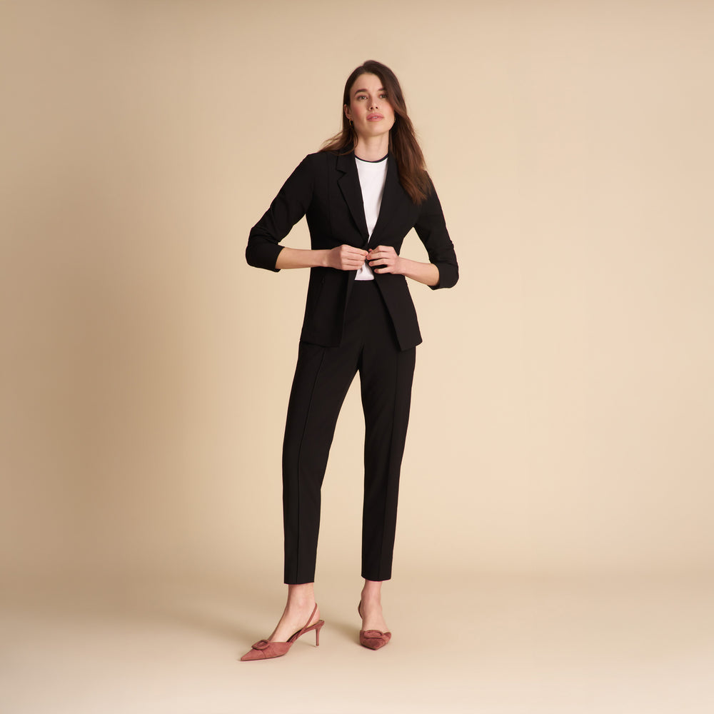 Women wearing the Leslie shirt in white on a beige background