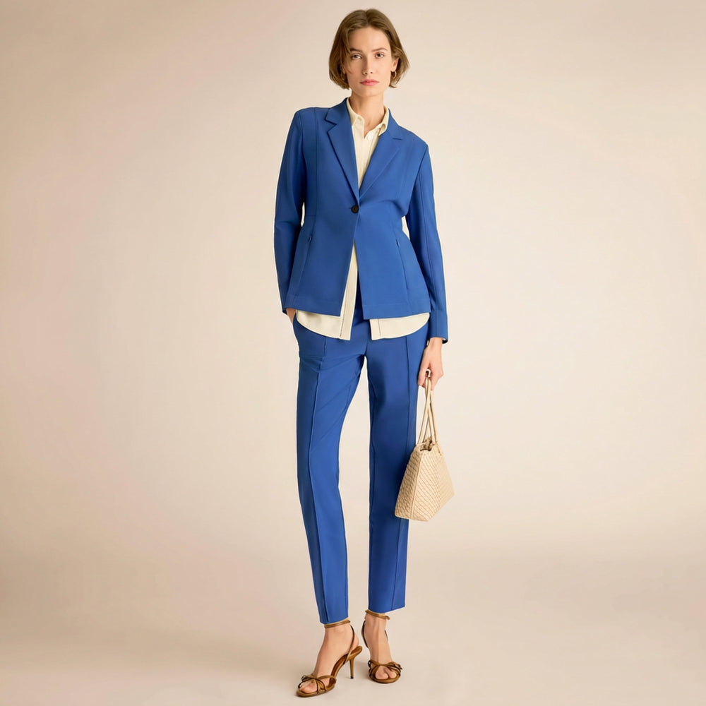 Woman wearing a blue suit with a beige background
