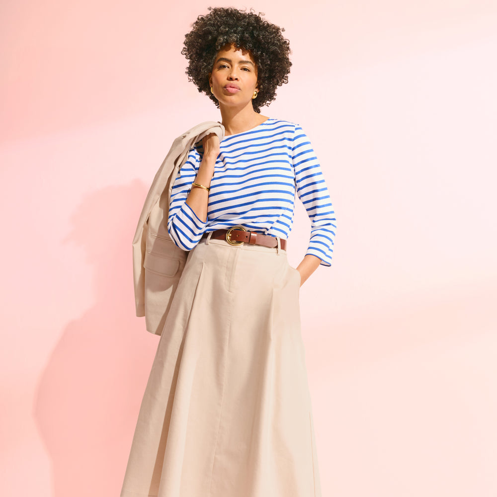 front image of a woman wearing the saint james t-shirt and olia skirt in natural