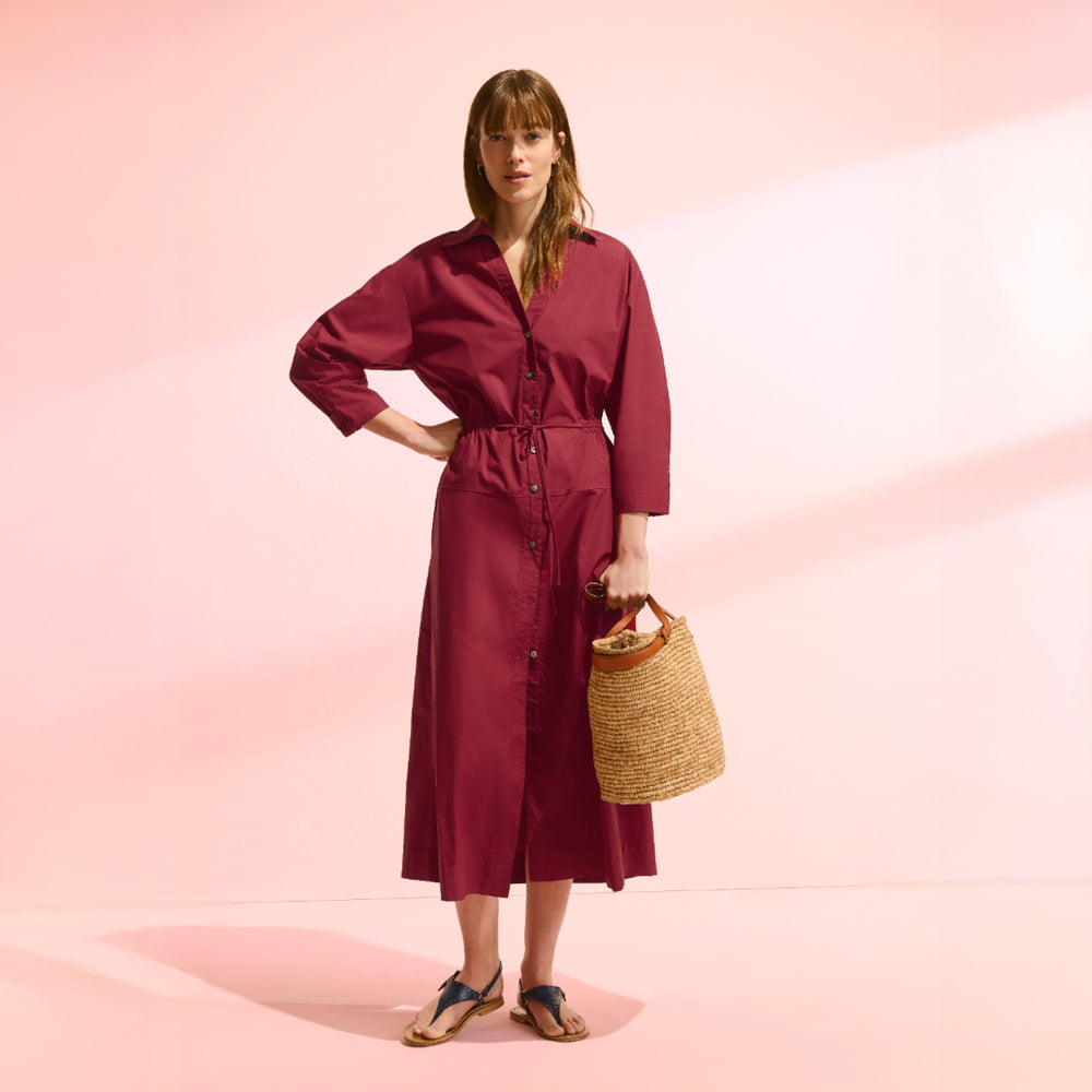 front image of a woman wearing the boden dress in cinnabar
