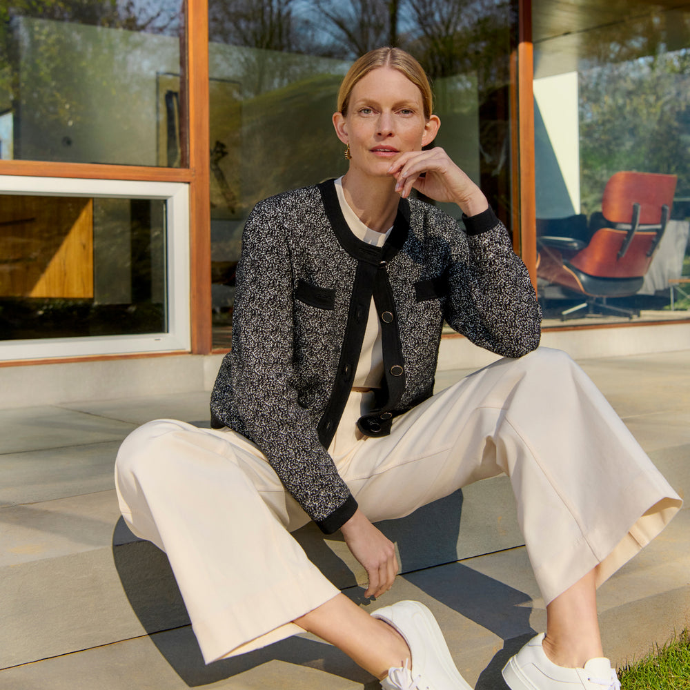 front image of a woman wearing the evangeline jacket in black/ivory