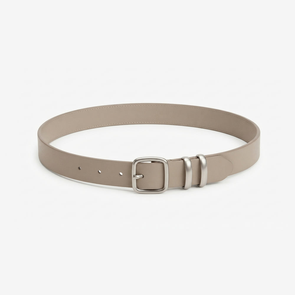 A slim taupe leather belt with a silver-tone metal buckle, photographed on a clean, light gray background.