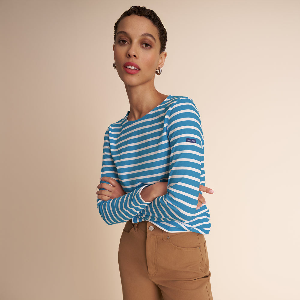 women in blue and white stripped shirt and beige pants