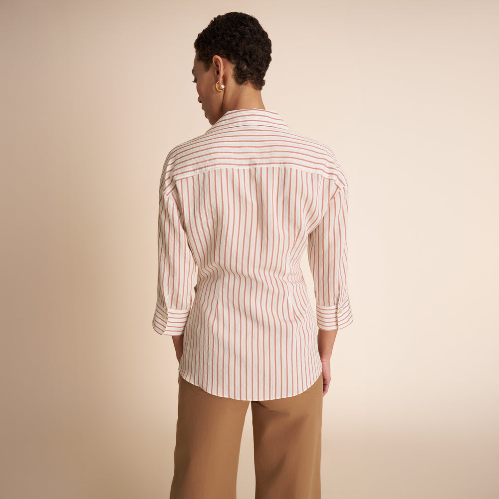 back of woman in stripped shirt.