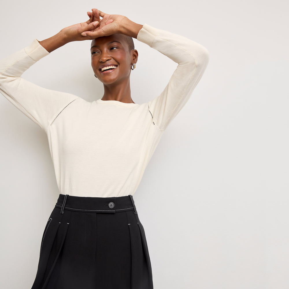front image of a woman wearing the larissa sweater in ivory
