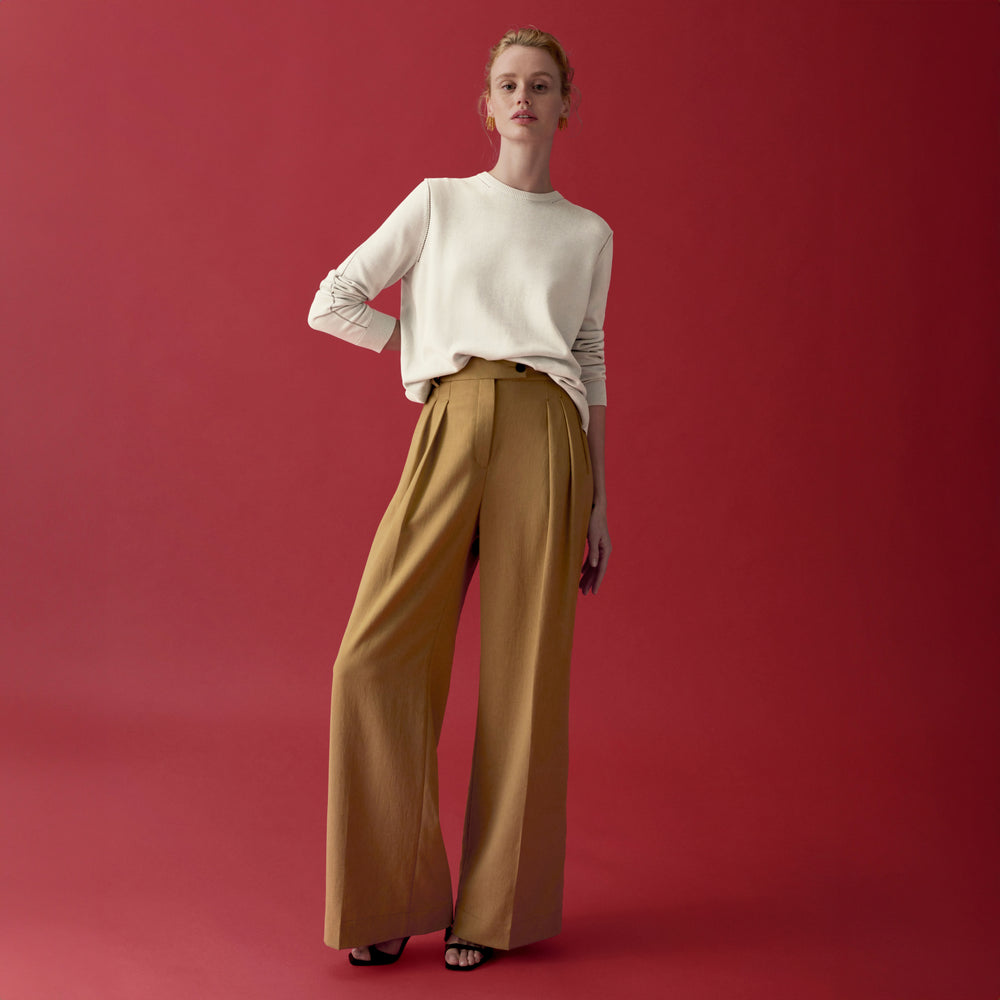 front image of a woman wearing the larissa sweater in ivory