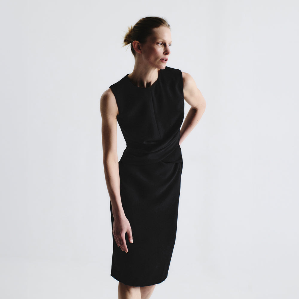 front image of a woman wearing the luz dress in black