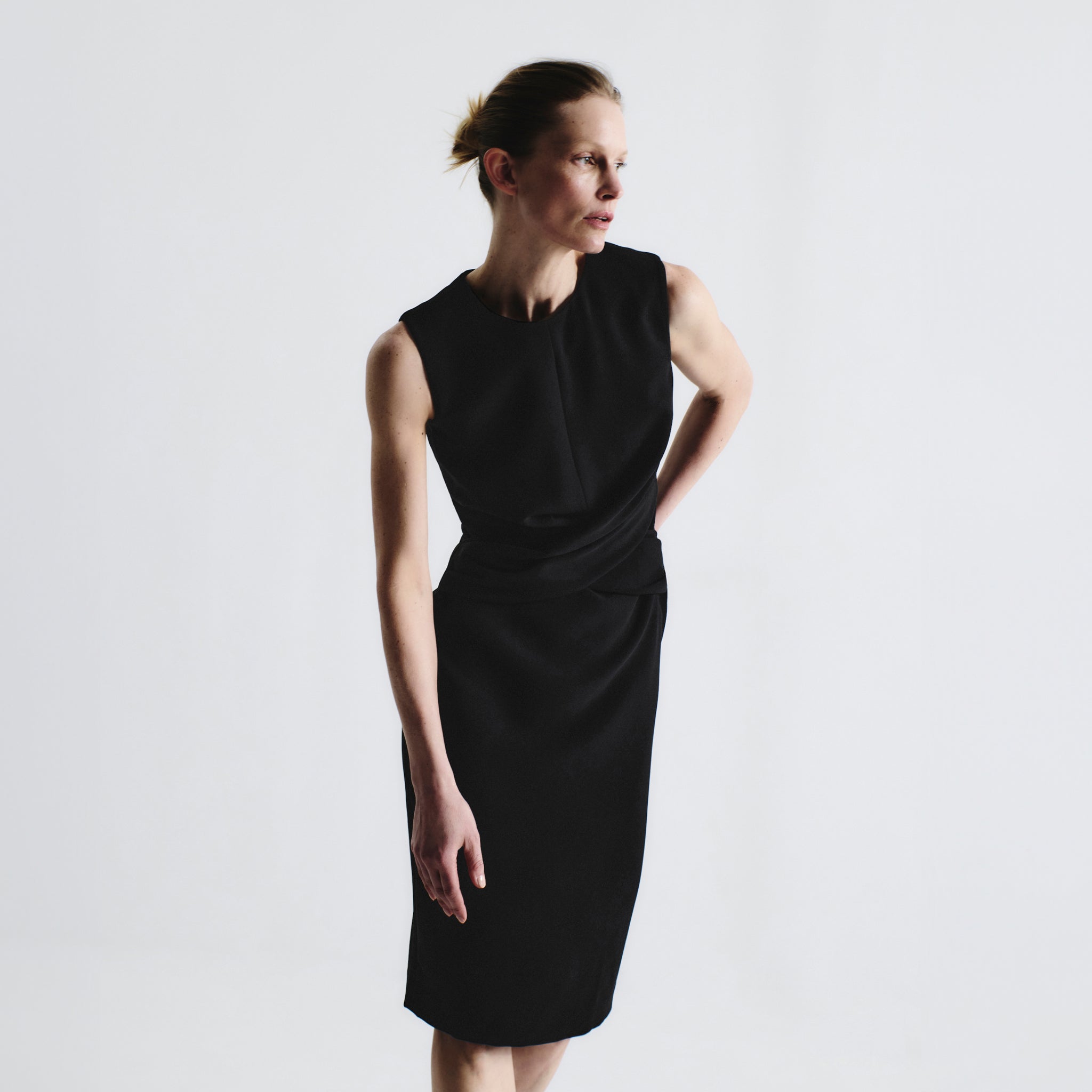front image of a woman wearing the luz dress in black
