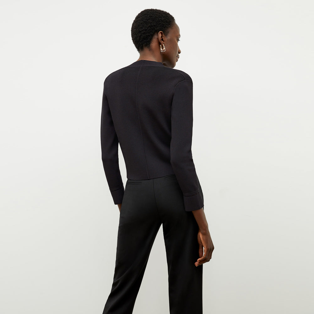 Back image of a woman standing wearing the Sant Ambroeus jardigan in black