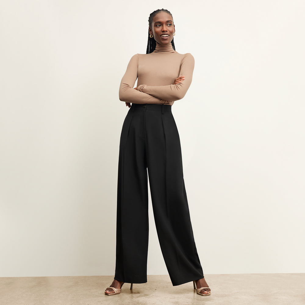 front image of a woman wearing the zuri pant in black