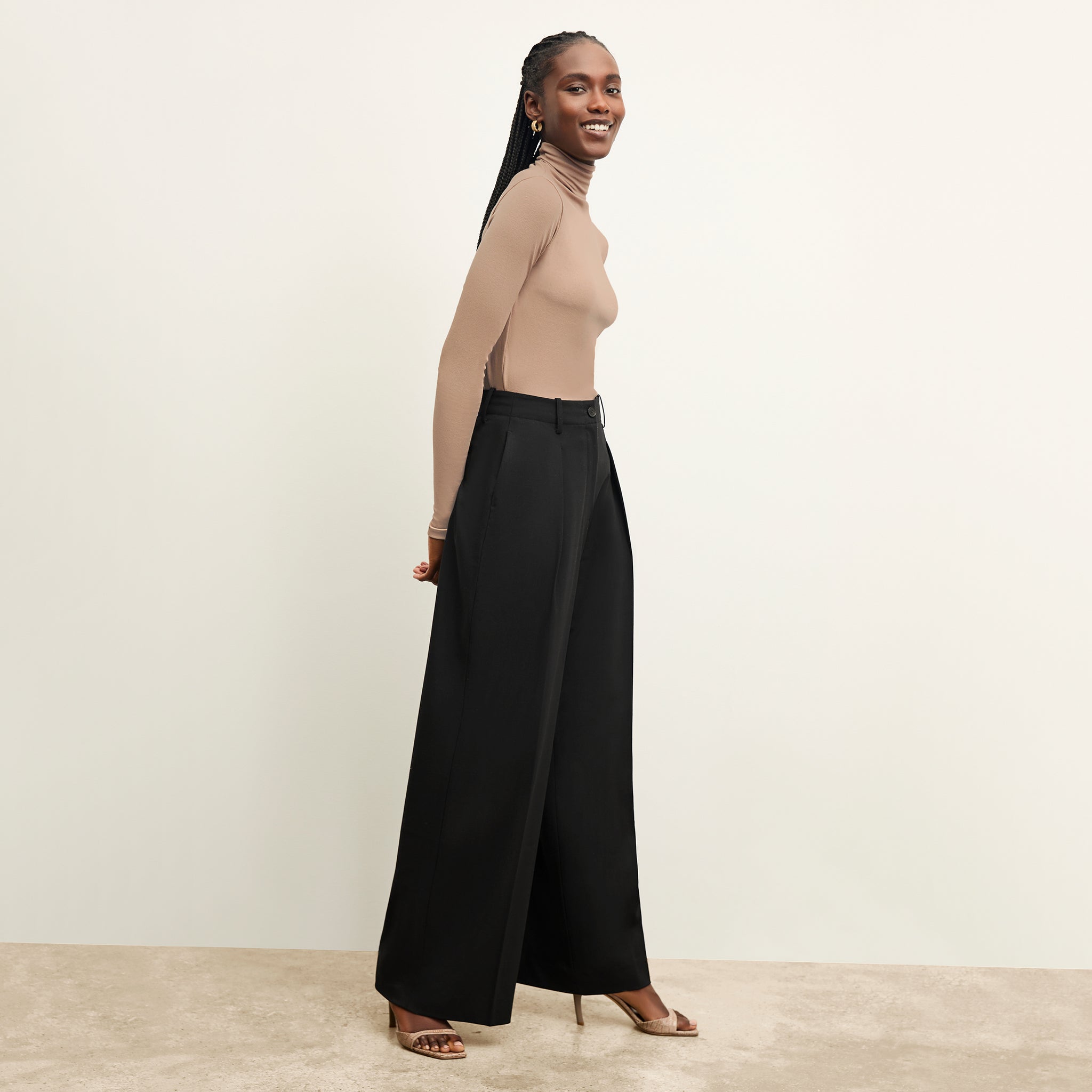 side image of a woman wearing the zuri pant in black