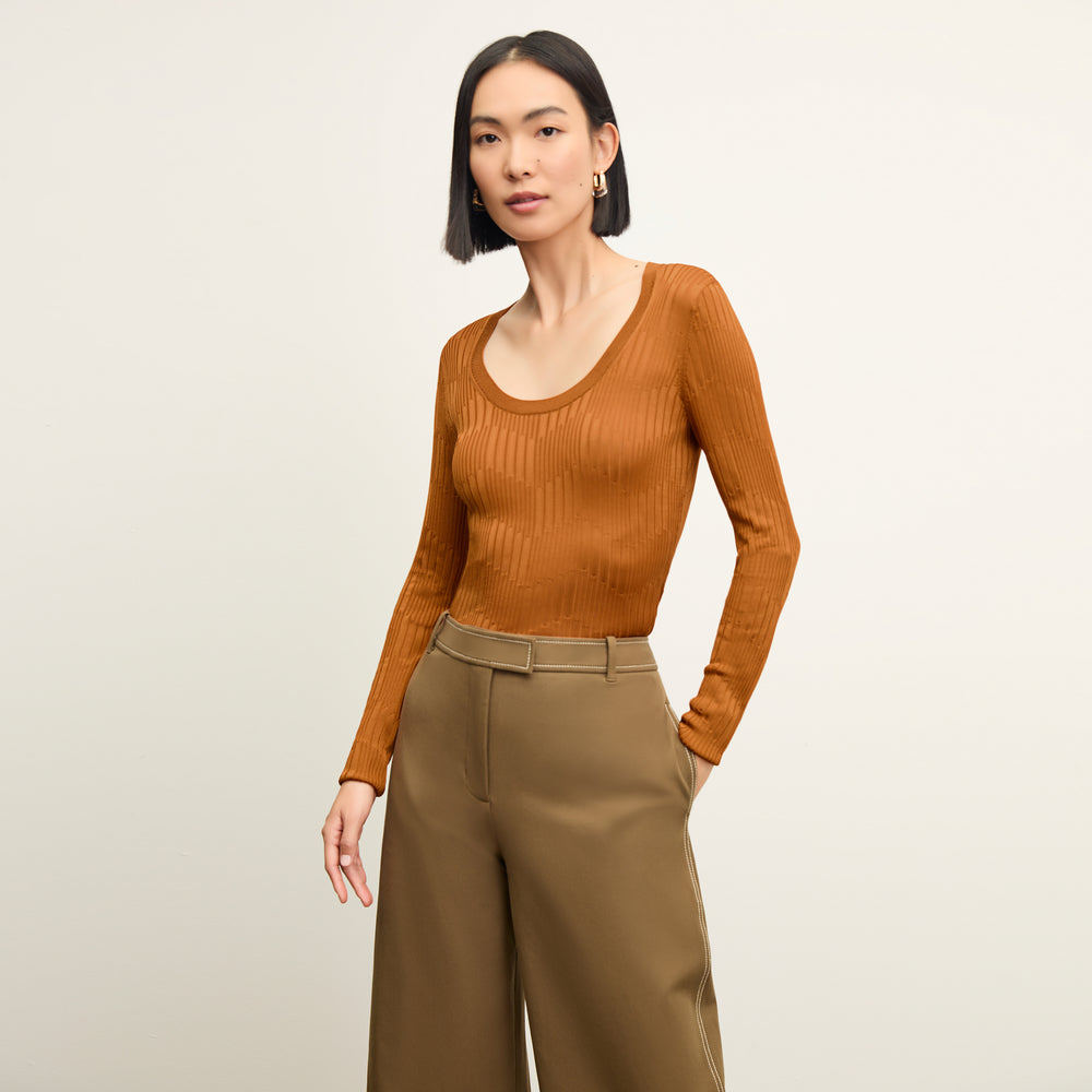 front image of a woman wearing the rae top in caramel