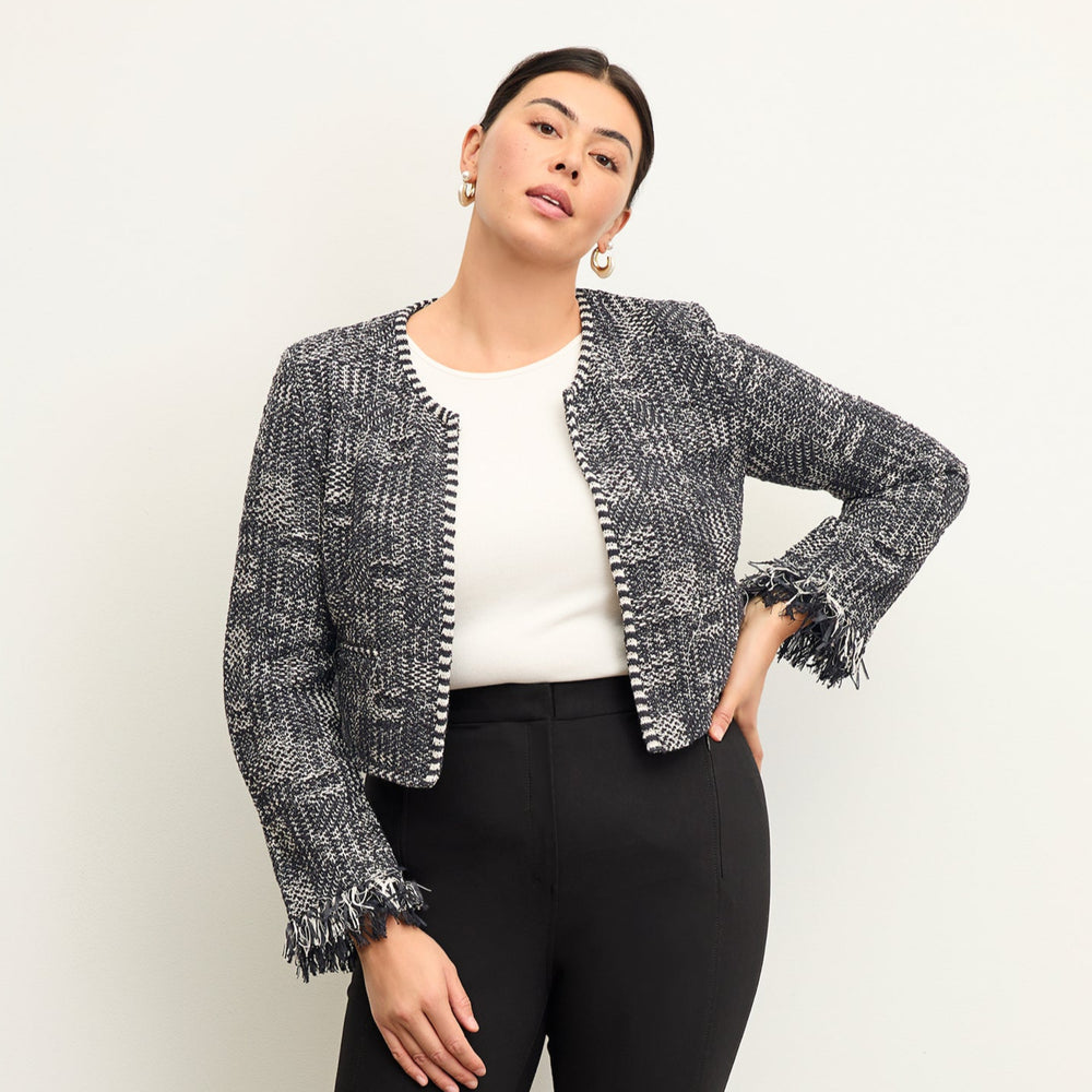 Front image of a woman standing wearing the lilia jacket in black and white