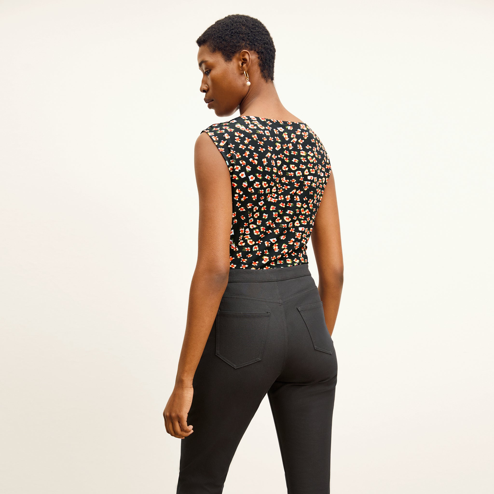 back image of a woman wearing the nora top in kaleidoscope print