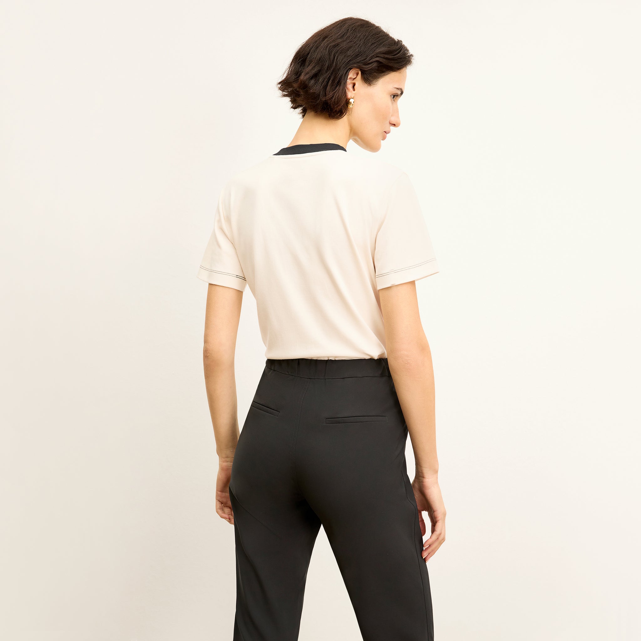 back image of a woman wearing the leslie t-shirt in embroidered ivory/black