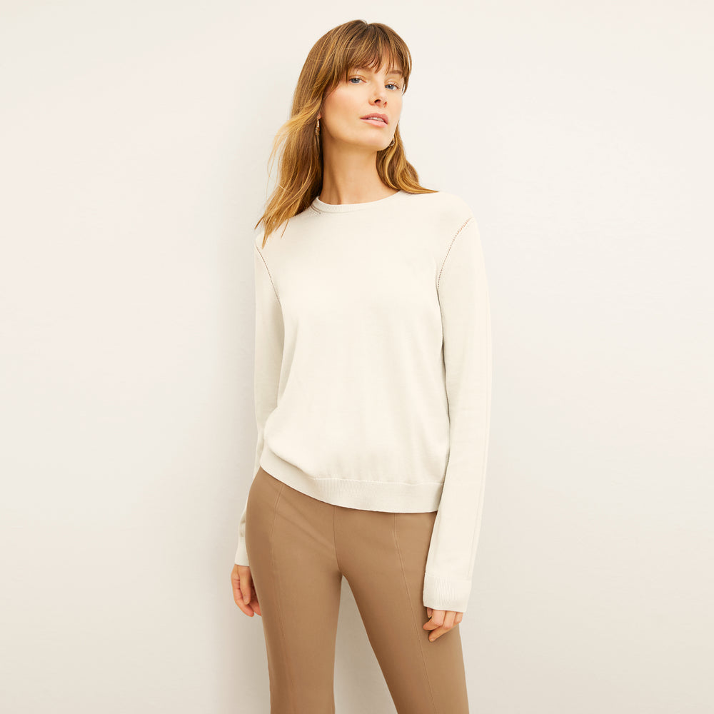 front image of a woman wearing the larissa sweater in ivory