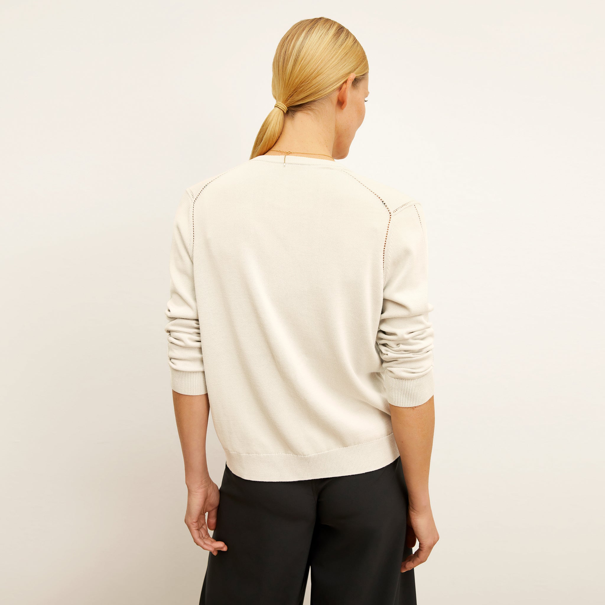 back image of a woman wearing the mel cardigan in ivory