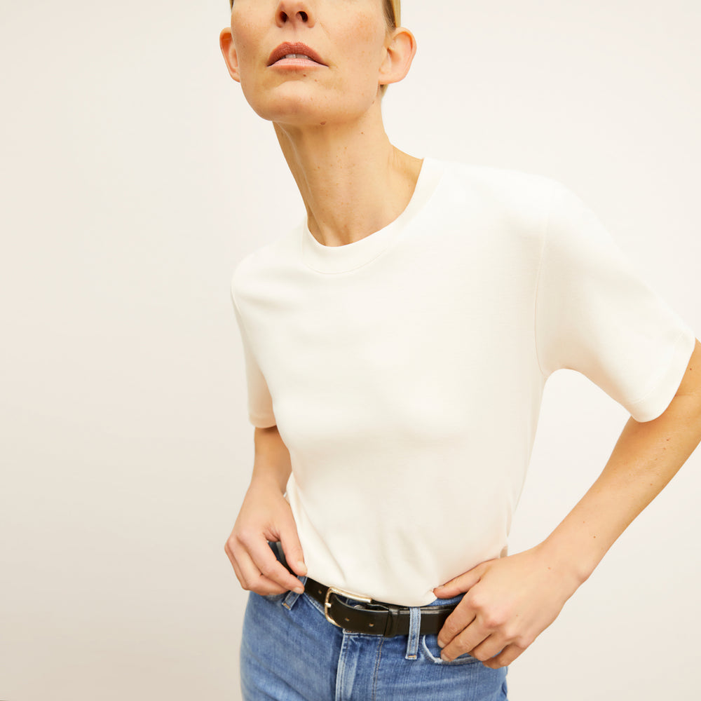 Front image of a woman wearing the leslie top in compact cotton in ivory
