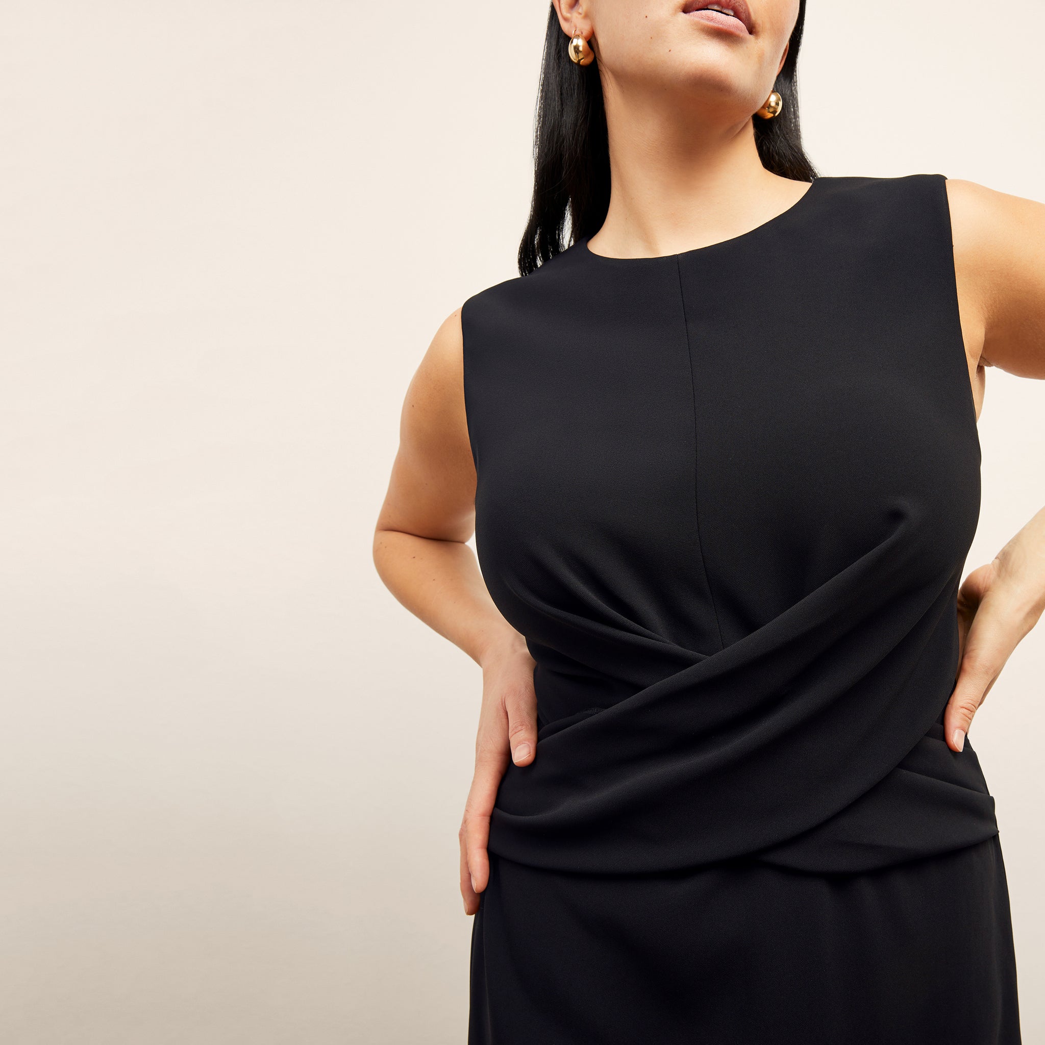 front image of a woman wearing the luz dress in black 