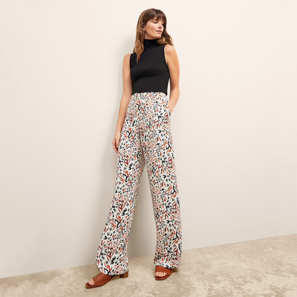 front image of a woman wearing the tinsley trousers in leopard sketch