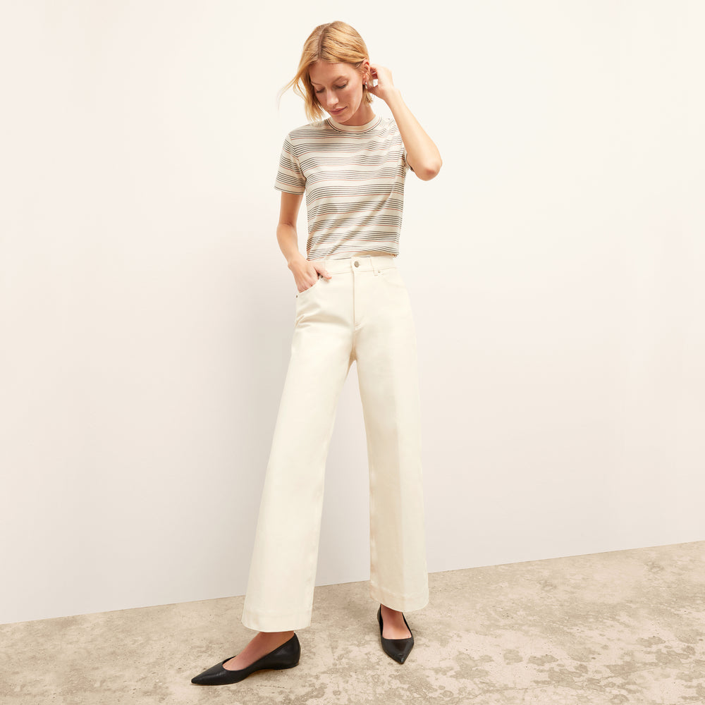 front image of a woman wearing the leslie t-shirt in signature stripe