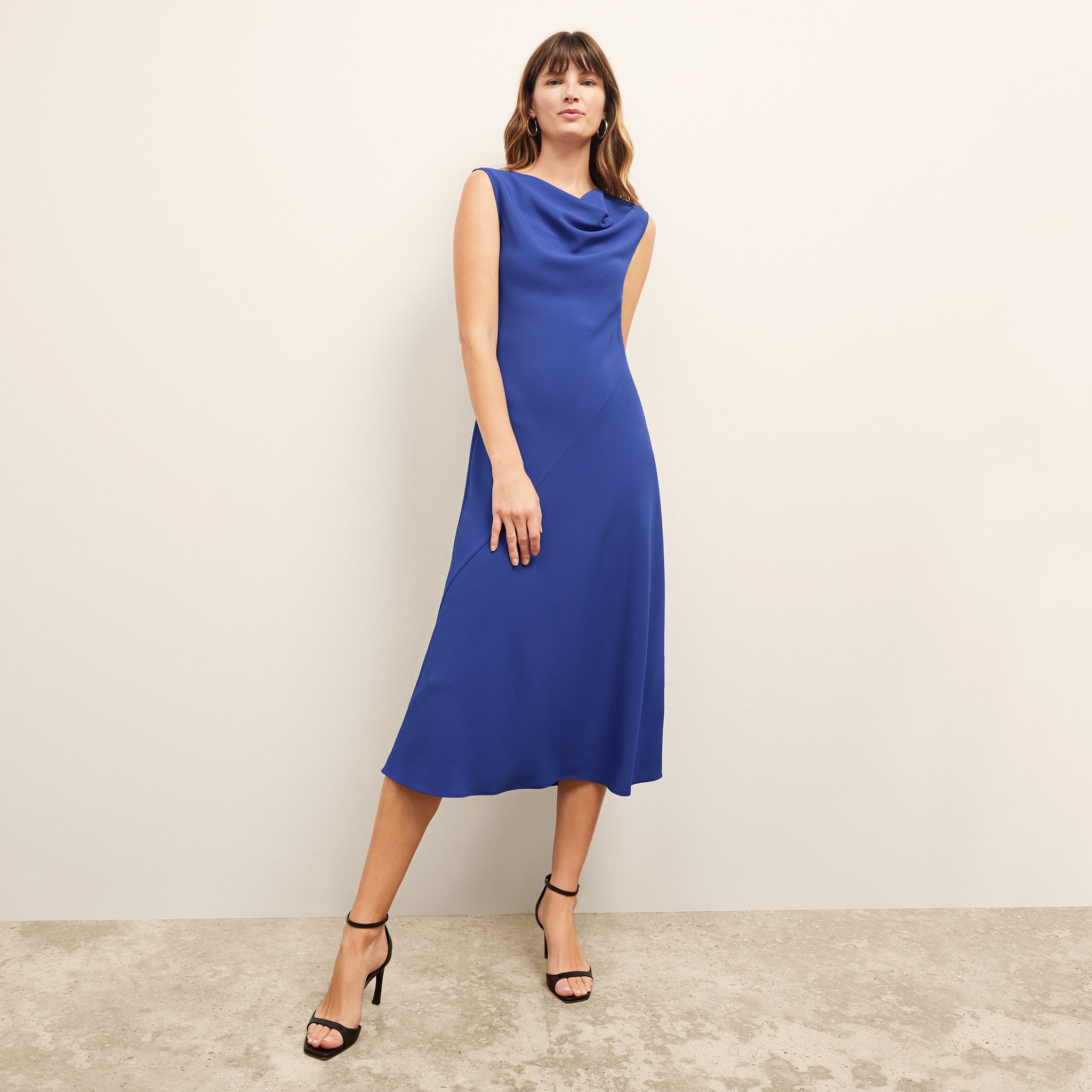 front image of a woman wearing the priya dress in electric blue 