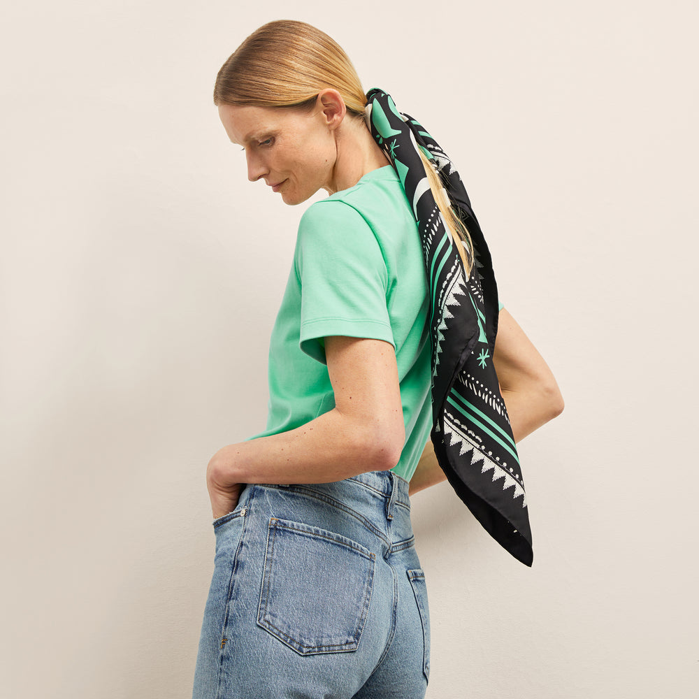 image of a woman wearing the washable silk scarf in seafoam icon print