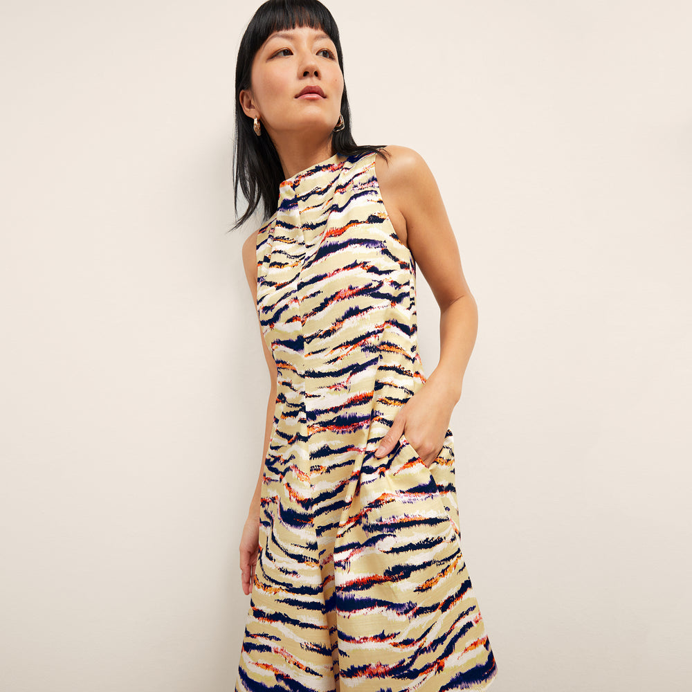 Front image of a woman wearing the malala dress in savannah print