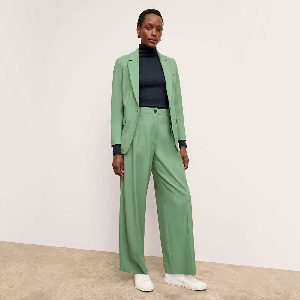 front image of a woman wearing the zuri pants in parisian green