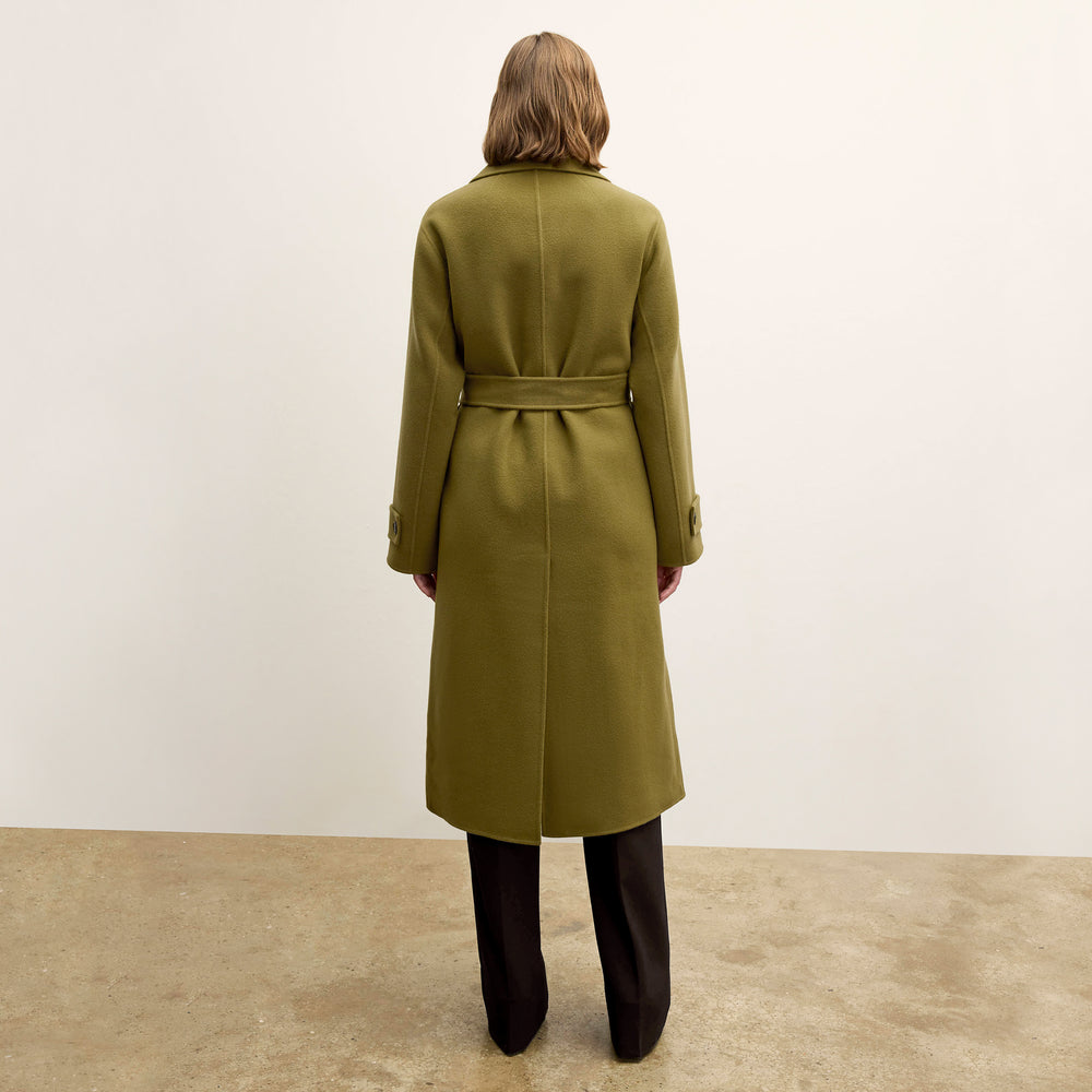 back image of a woman wearing the viola coat in pistachio