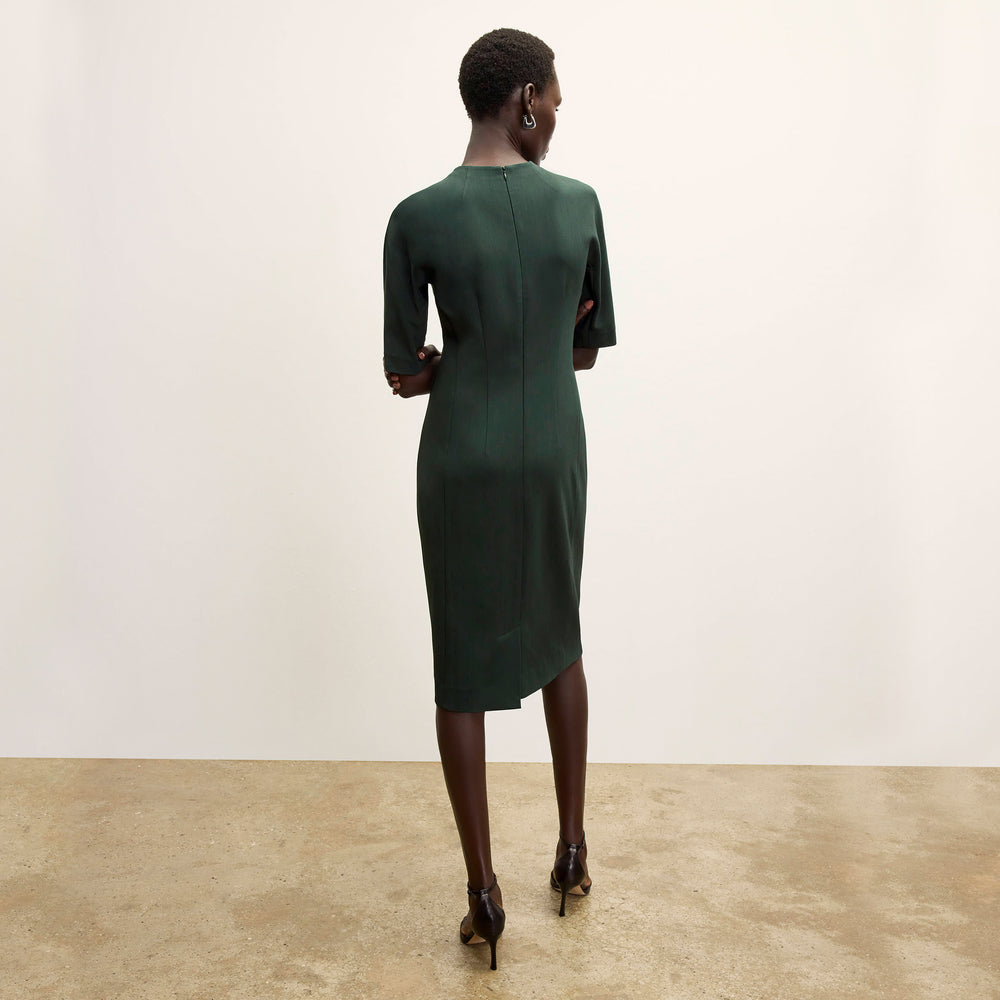 back image of a woman wearing the farnoosh dress in emerald
