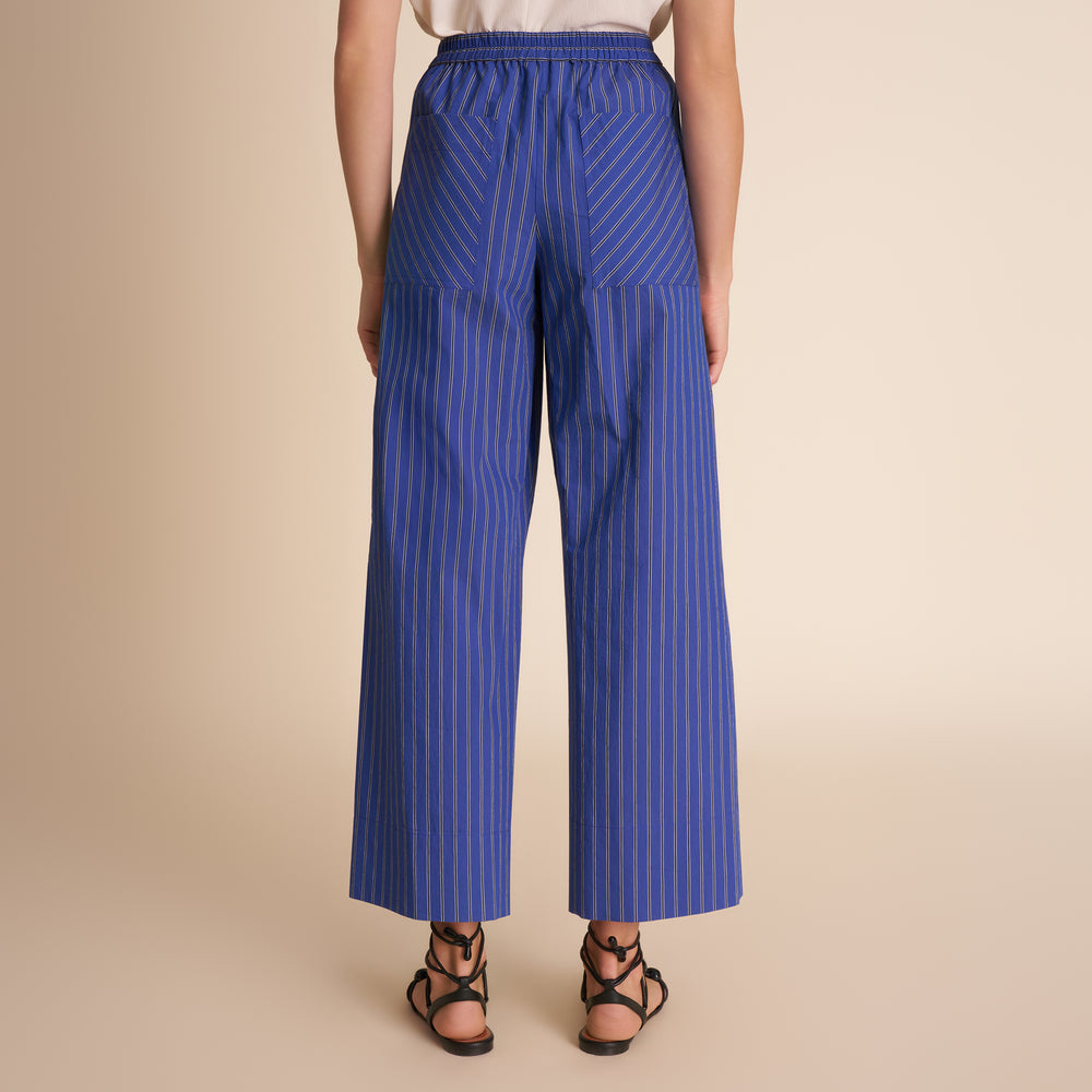 woman in blue stripped pants