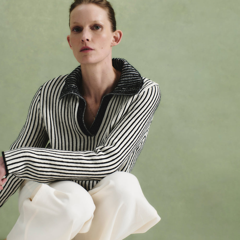 front image of a woman wearing the maja sweater in black/ivory