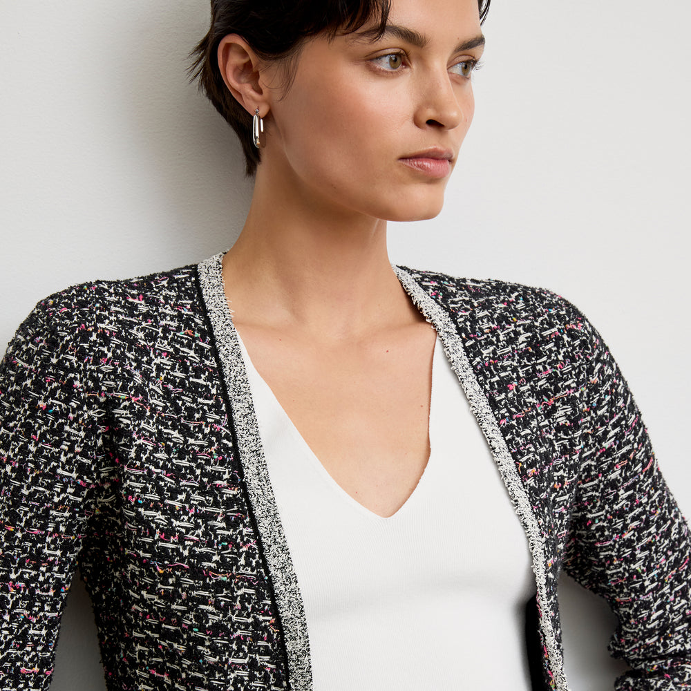 front image of a woman wearing the meena jardigan in boucle tweed black/white