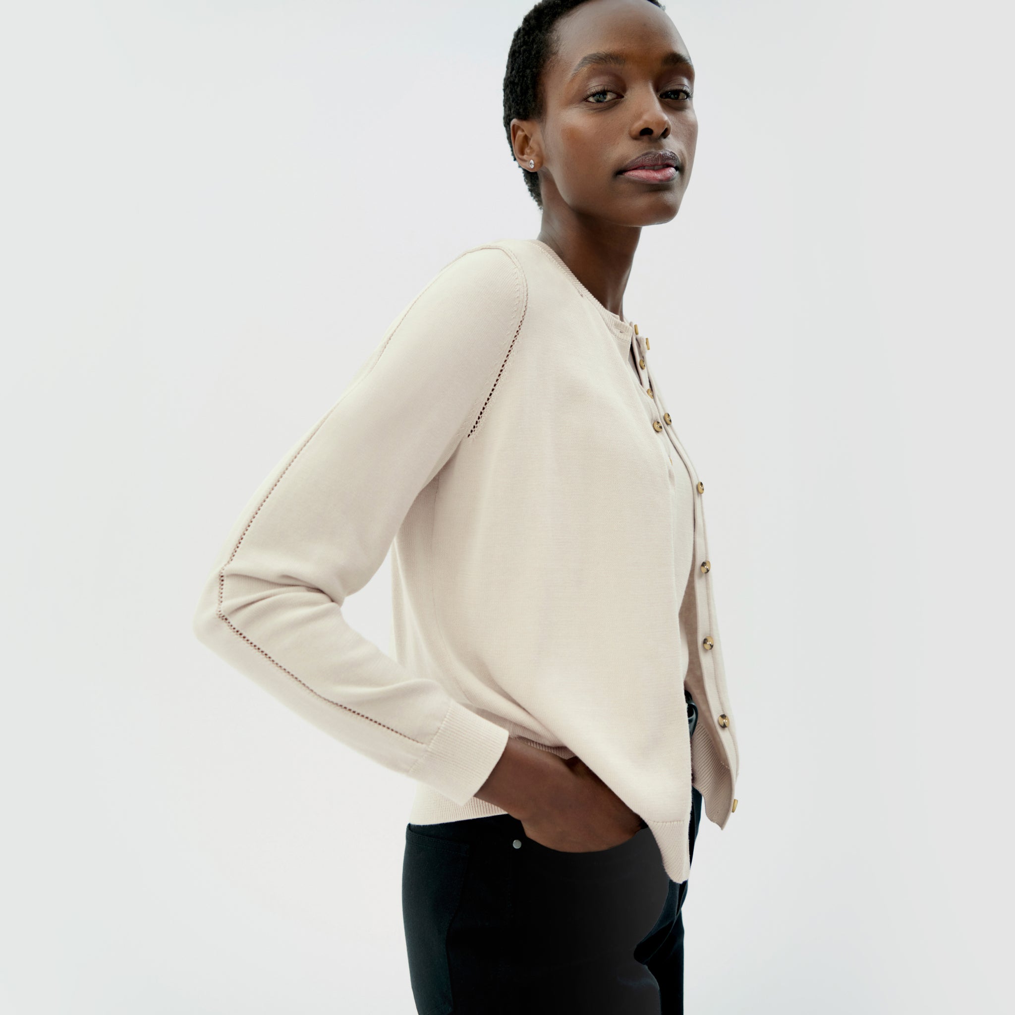 front image of a woman wearing the mel cardigan in ivory