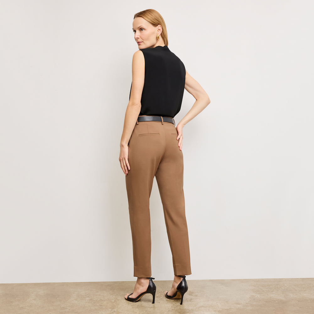 image of a woman standing wearing the Mejia pant in camel