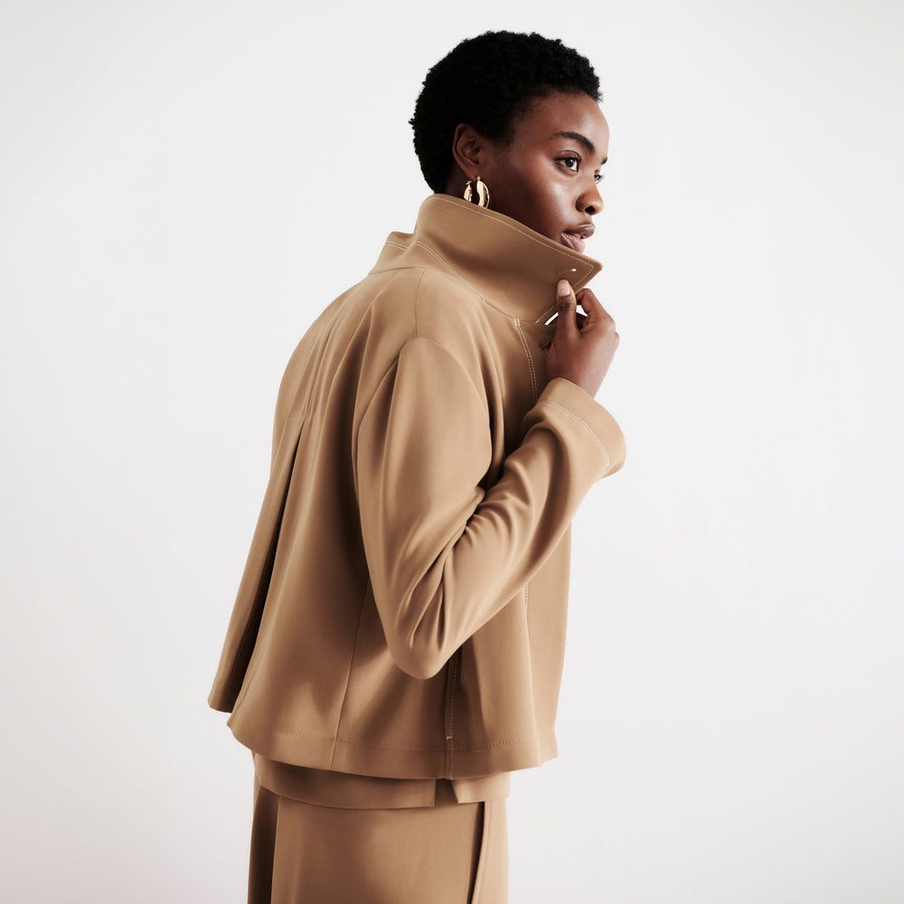 front image of a woman wearing the nicky jacket in saddle