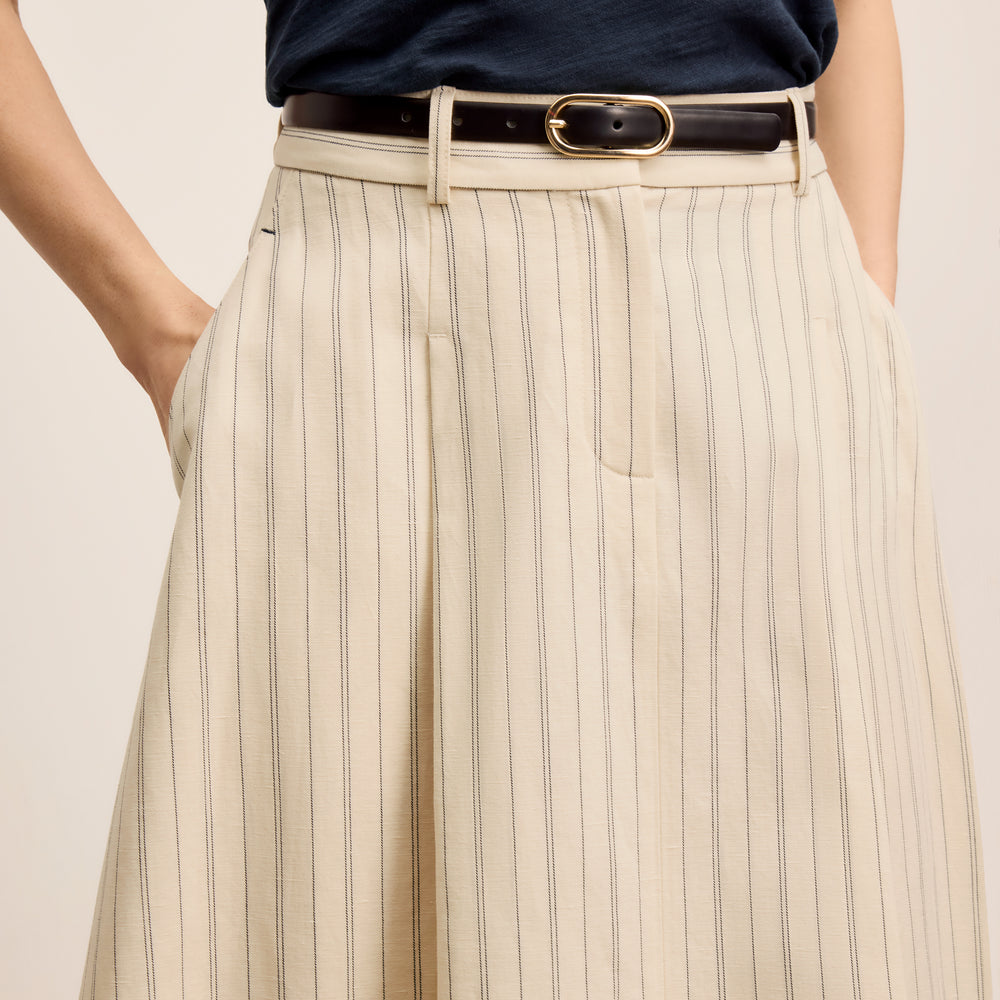 front image of a woman wearing the olia skirt in linen stripe